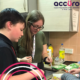 Accuro volunteer Amy helping Cool Connections member to prepare food in the kitchen