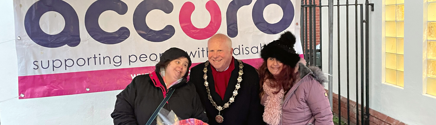 Two Accuro Adult Friendship Scheme members with the Dunmow Mayor in front of an Accuro banner