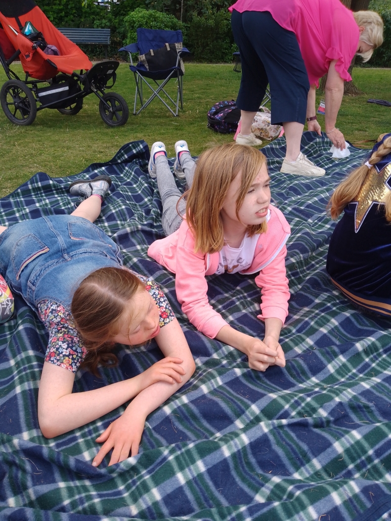 Jubilee Event Two accuro members lying on a picnic blanket