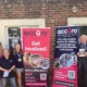 Accuro employees and volunteers with advertising stands for volunteers.