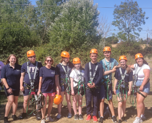 Accuro employees and staff wearing hard hats for outdoor activities.