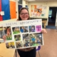 Accuro member holding a poster displaying photos of social opportunities.