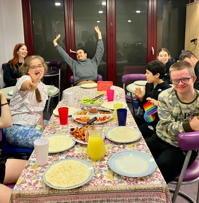 Loughton Youth Group enjoying fajitas together at a dining room table, celebrating World Food Day