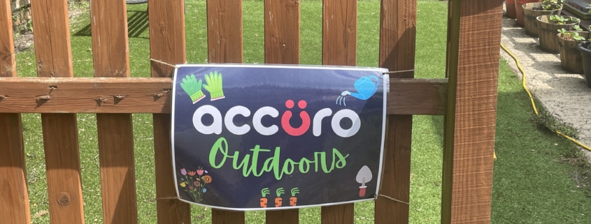 Accuro Outdoors sign on fence in front of Accuro allotment